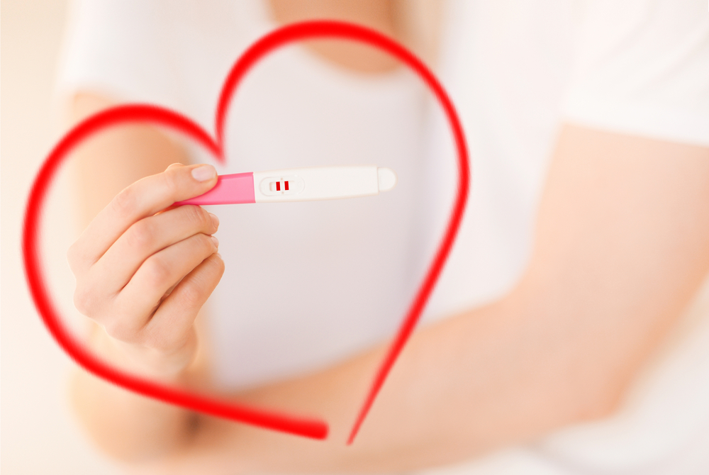 woman and man hands with pregnancy test